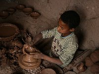 Draa Valley  A young potter -- he sits in a whole and turns the wheel with foot pedals