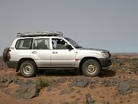 From desert to Marrakesh  Our 4wd parked on a ridge where the stones contain fossiles