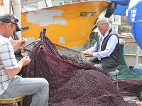 Istanbul - Bosphorus tour  At Anadolu Kavağı, the terminus stop, on the Asian side, fishermen repairing their nets