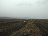 Absolutly flat and desolate lava field along the road (recognizable almost only by the yellow road markers) in the Naefurholtsfjöll; remains left from eruptions of Hekla ("the queen of Icelandic volcanoes") - only brown and black colors. Incredible!